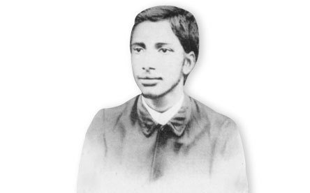 A portrait of Anukul as a boy, in a buttoned coat