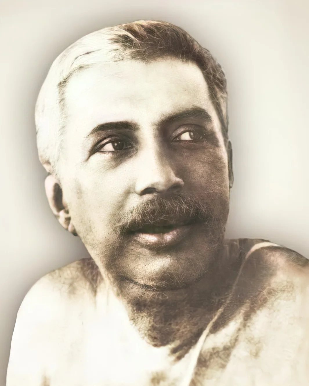 Thakur Anukulchandra, a portrait, looking to one side with a gentle expression
