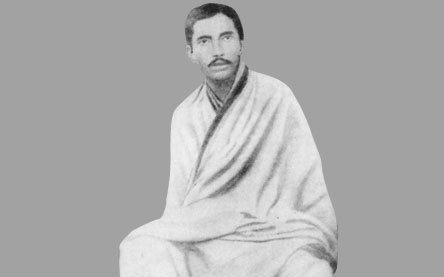 Young Anukulchandra seated, a shawl around his shoulders