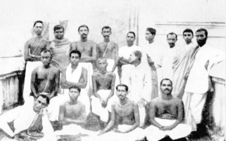 A group photograph of young men, some seated and some standing; Thakur stands third from the left